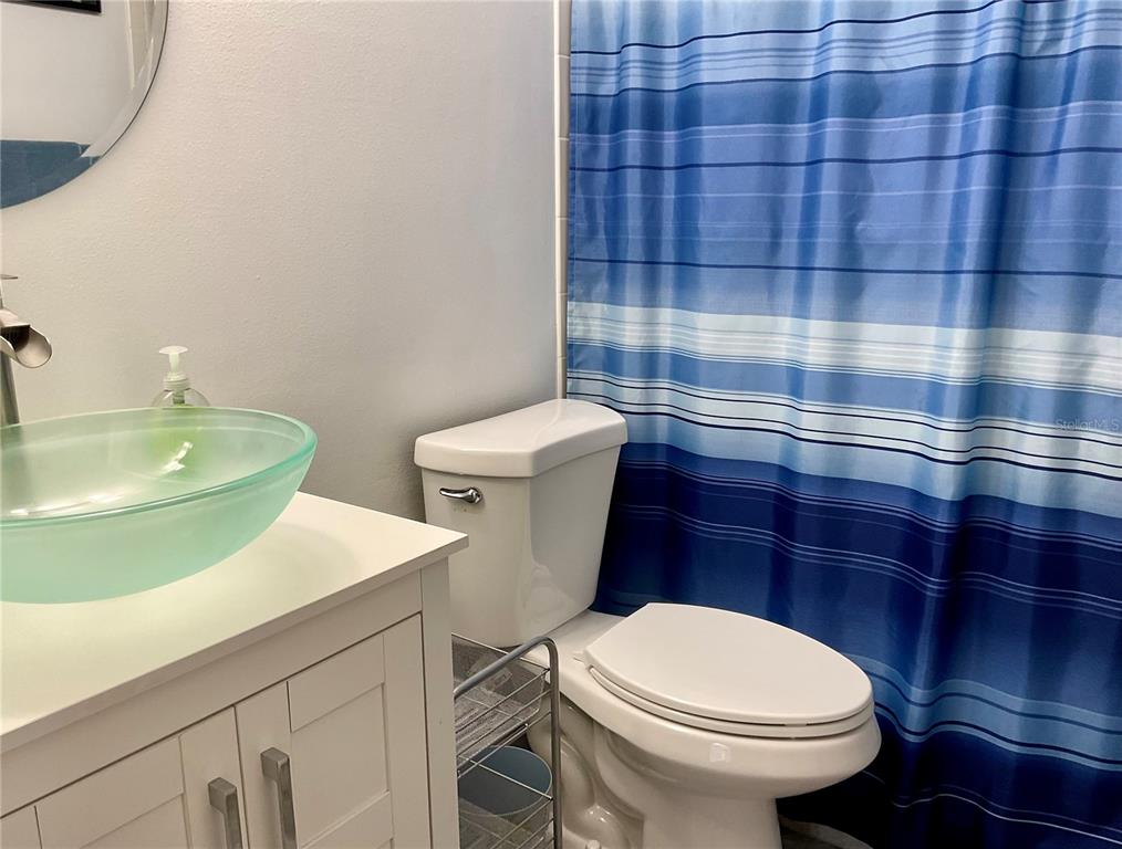 3213 South Beneva Road, Unit 204 Sarasota, FL 34232 - Photo 14 of 18 a bathroom with a sink a toilet and a mirror