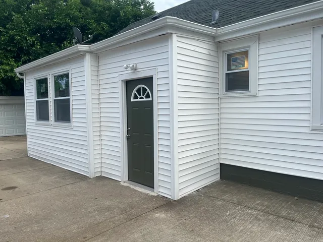 a view of a white house with a small space