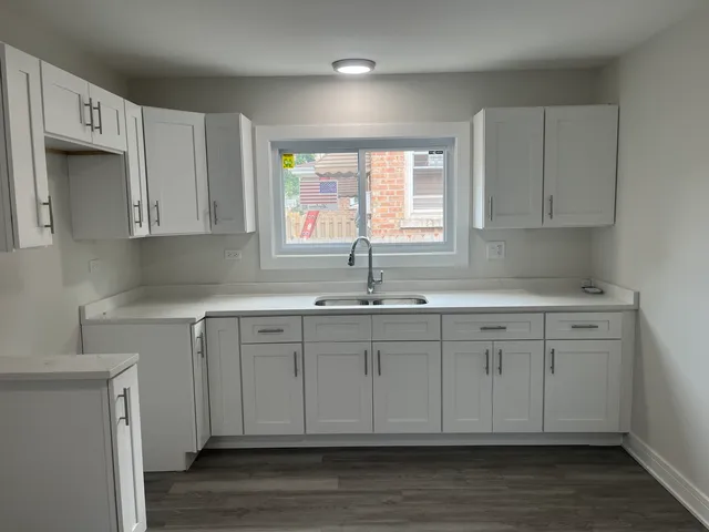 a kitchen with stainless steel appliances granite countertop a sink a stove a microwave a refrigerator and cabinets