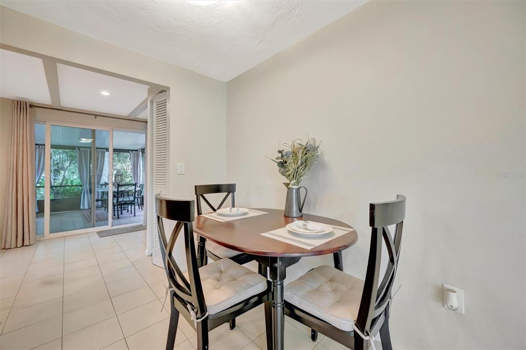 4478 Coco Ridge Circle Sarasota, FL 34233 - Photo 12 of 85 a view of a dining room with furniture and wooden floor