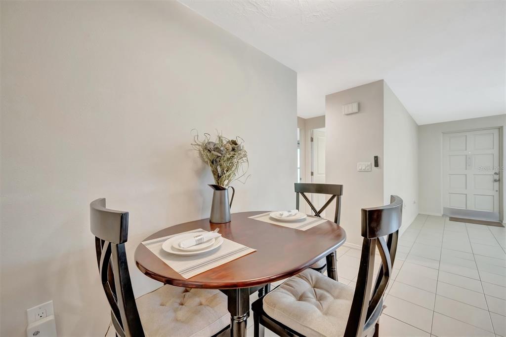 4478 Coco Ridge Circle Sarasota, FL 34233 - Photo 27 of 85 a view of a dining room with furniture and wooden floor