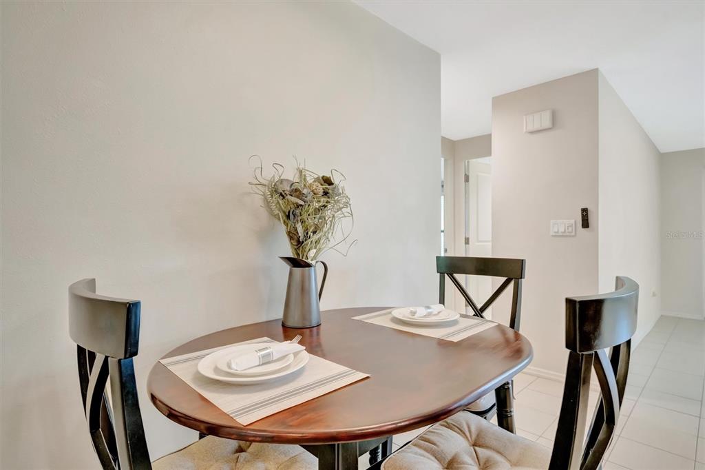 4478 Coco Ridge Circle Sarasota, FL 34233 - Photo 28 of 85 a view of a dining room with furniture and wooden floor