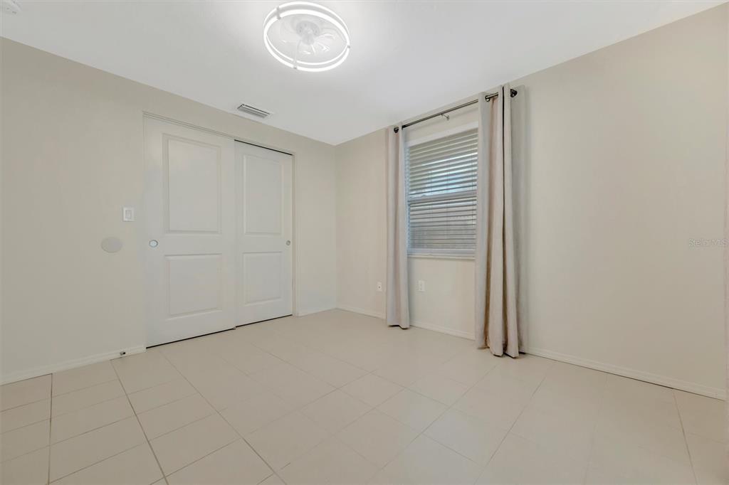 4478 Coco Ridge Circle Sarasota, FL 34233 - Photo 42 of 85 an empty room with a empty space and windows