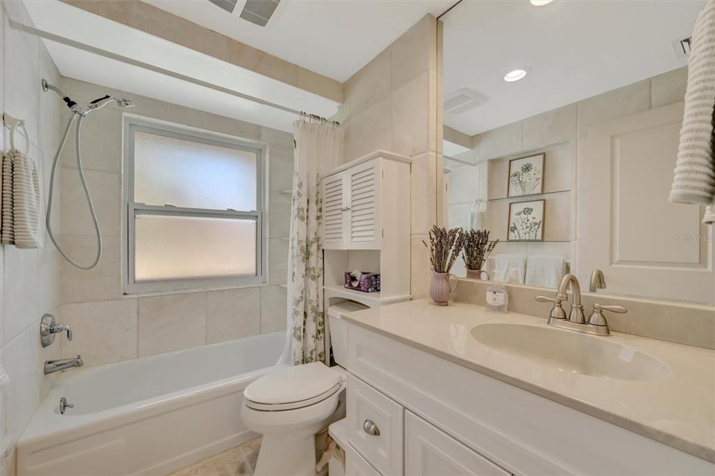 4478 Coco Ridge Circle Sarasota, FL 34233 - Photo 43 of 85 a bathroom with a granite countertop sink a toilet and shower