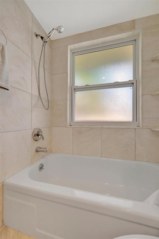 4478 Coco Ridge Circle Sarasota, FL 34233 - Photo 45 of 85 a bathroom with a bathtub and a shower
