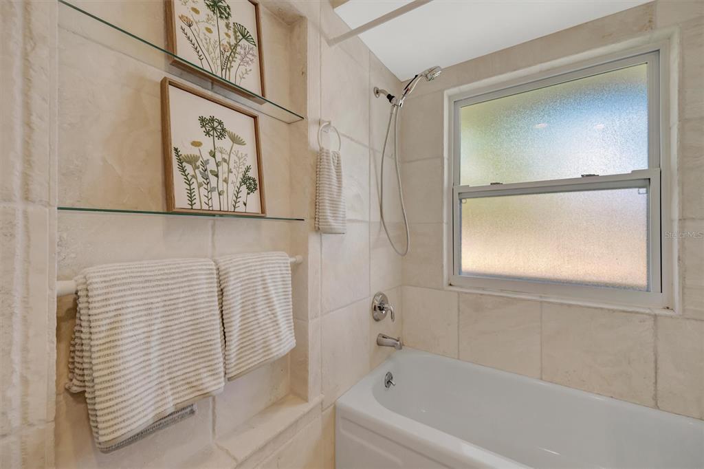 4478 Coco Ridge Circle Sarasota, FL 34233 - Photo 46 of 85 a bathroom with a bathtub and a shower