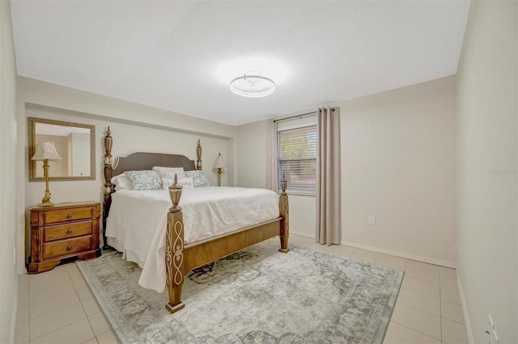 4478 Coco Ridge Circle Sarasota, FL 34233 - Photo 47 of 85 a bedroom with a bed and a dresser