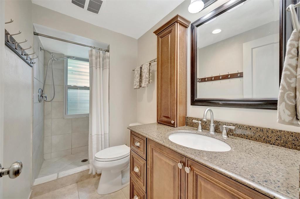 4478 Coco Ridge Circle Sarasota, FL 34233 - Photo 51 of 85 a bathroom with a granite countertop sink toilet and shower