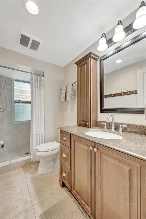 4478 Coco Ridge Circle Sarasota, FL 34233 - Photo 52 of 85 a bathroom with a granite countertop sink mirror vanity and toilet
