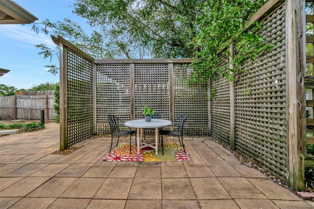 4478 Coco Ridge Circle Sarasota, FL 34233 - Photo 66 of 85 a backyard of a house with table and chairs