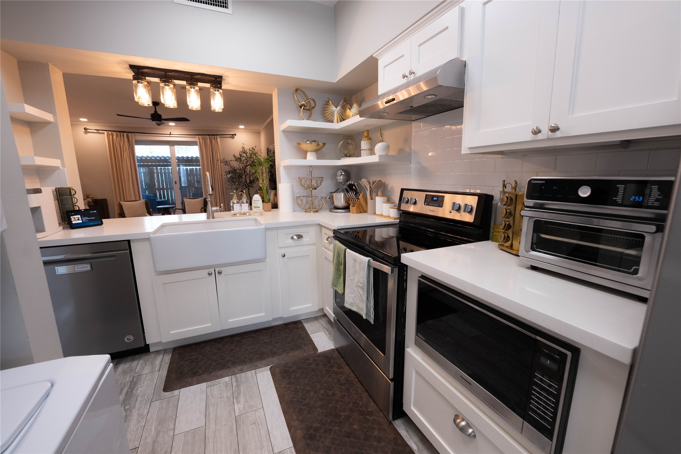 7447 Brompton Street, Unit 7447 Houston, TX 77025 - Photo 11 of 27 Updated kitchen featuring stainless steel appliances and quartz countertops, perfect for preparing your favorite meals.