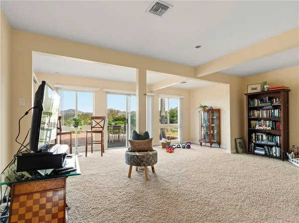 a living room with furniture a rug and a large window