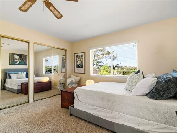 a bedroom with a large bed and a window