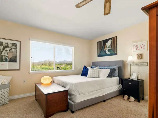 a bedroom with a bed and a painting on the wall