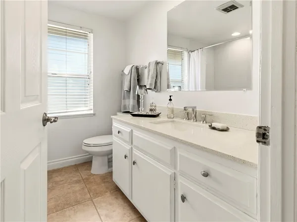 a bathroom with a sink toilet and mirror