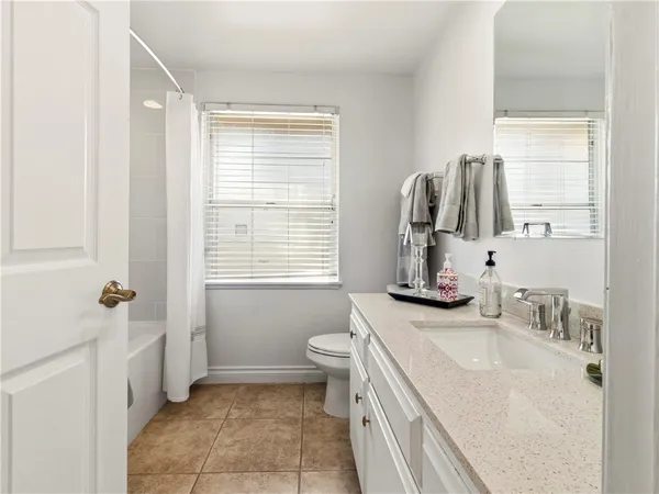 a bathroom with a sink toilet and window