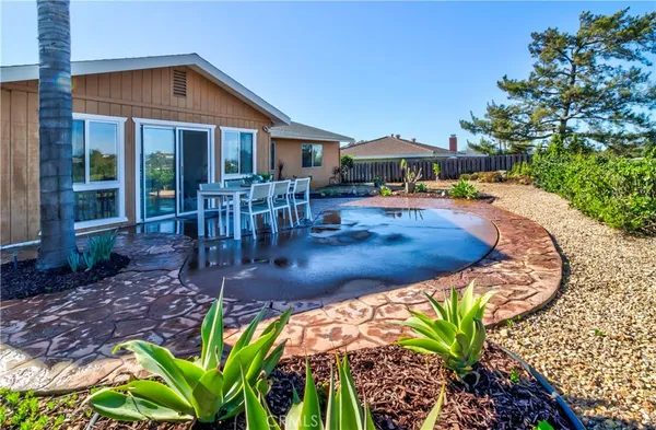a view of a house with backyard porch and sitting area