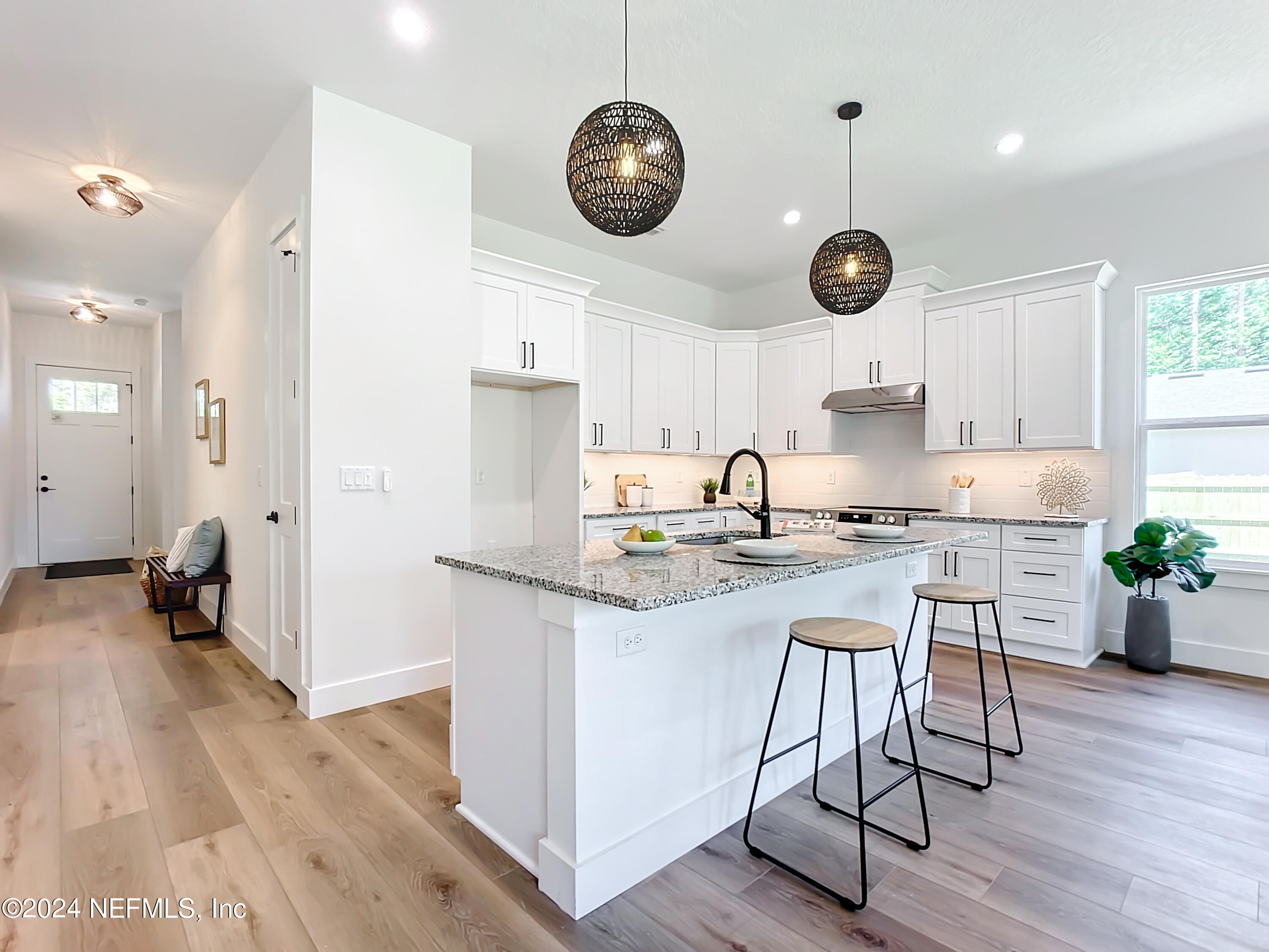 2909 Brougham Jacksonville, FL 32246 - Photo 10 of 46 an open kitchen with wooden floor and stainless steel appliances