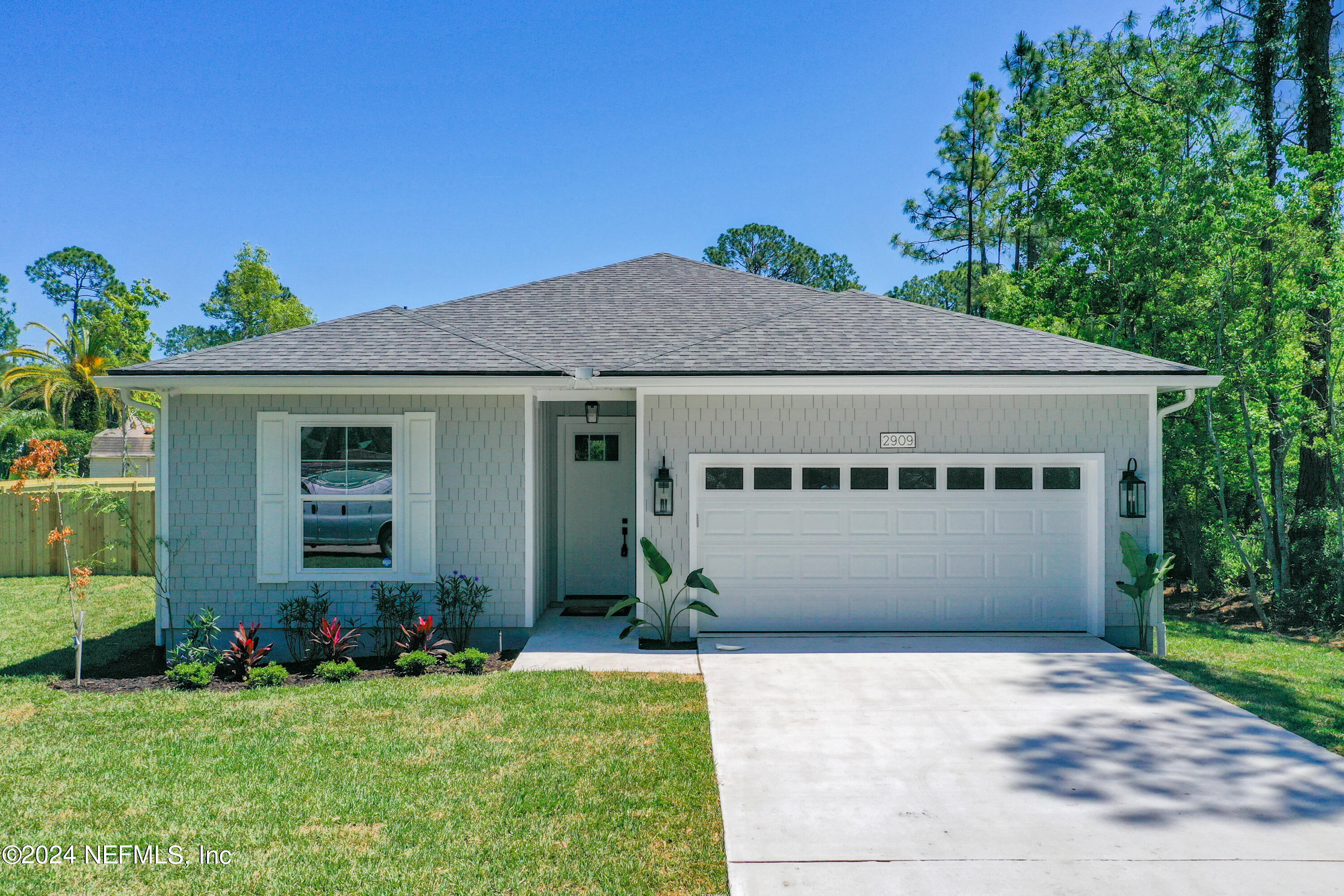2909 Brougham Jacksonville, FL 32246 - Photo 2 of 46 a front view of a house with a garden