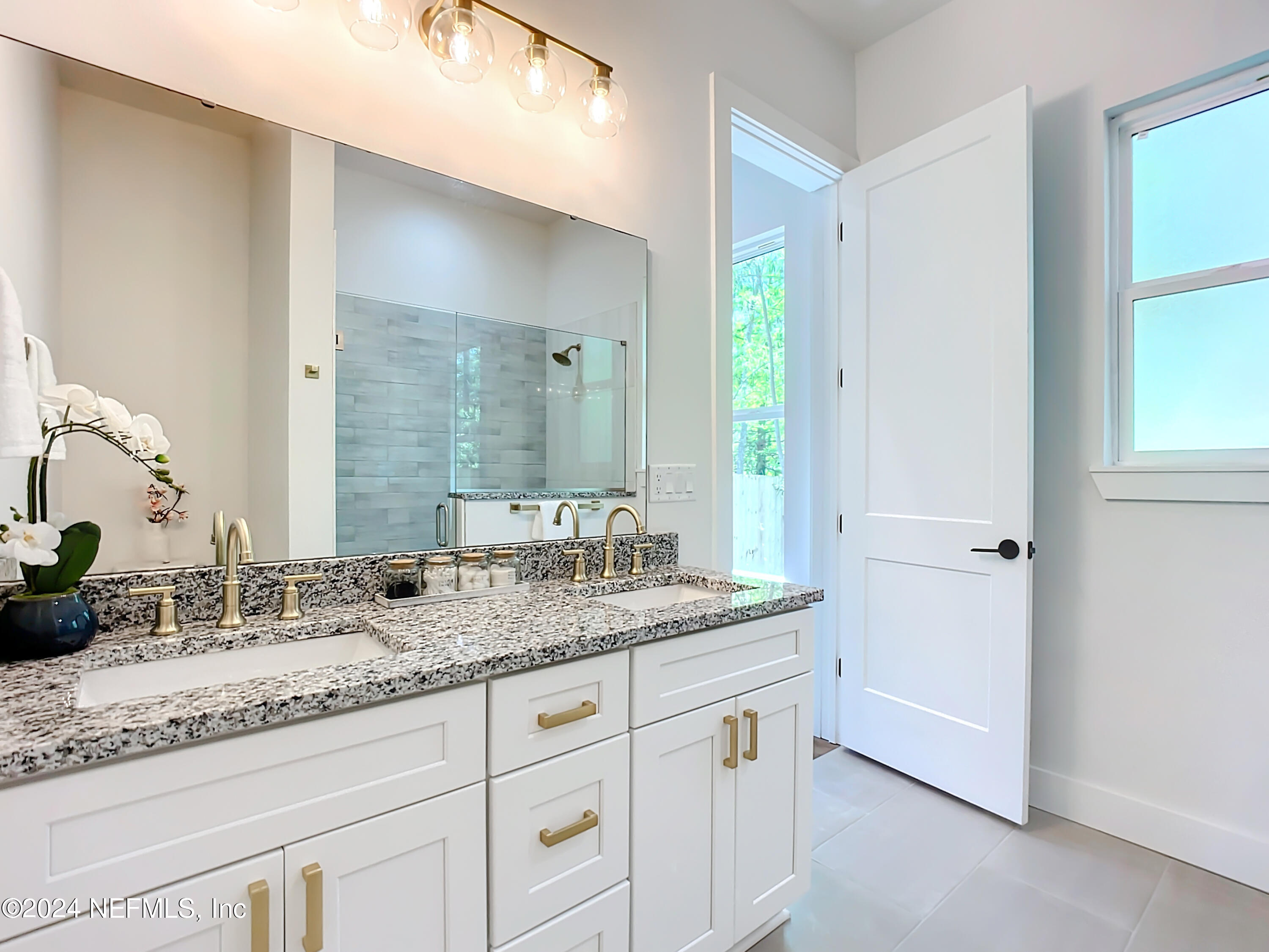 2909 Brougham Jacksonville, FL 32246 - Photo 20 of 46 a bathroom with a granite countertop double vanity sink and mirror