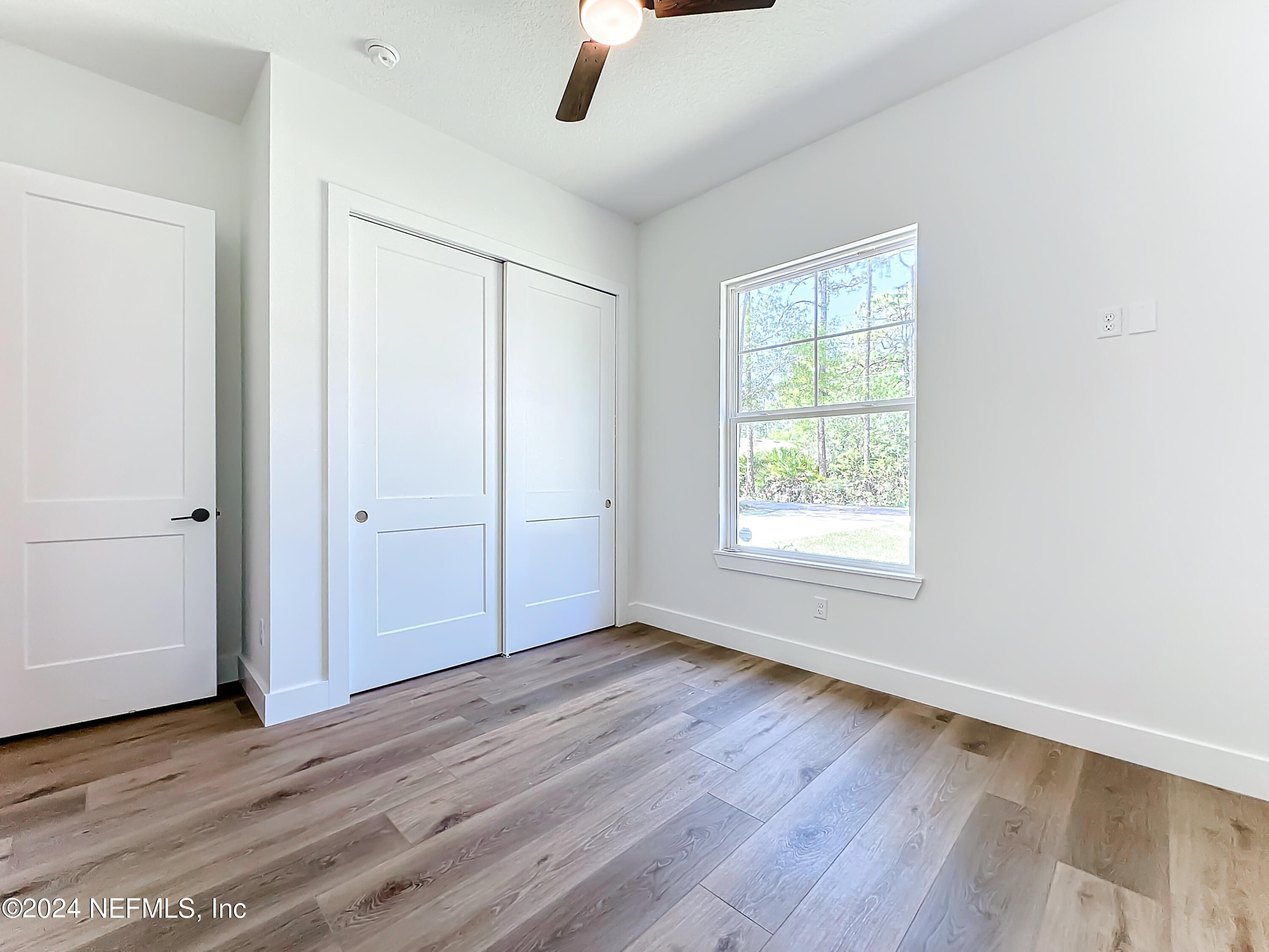 2909 Brougham Jacksonville, FL 32246 - Photo 27 of 46 an empty room with wooden floor cabinet and windows