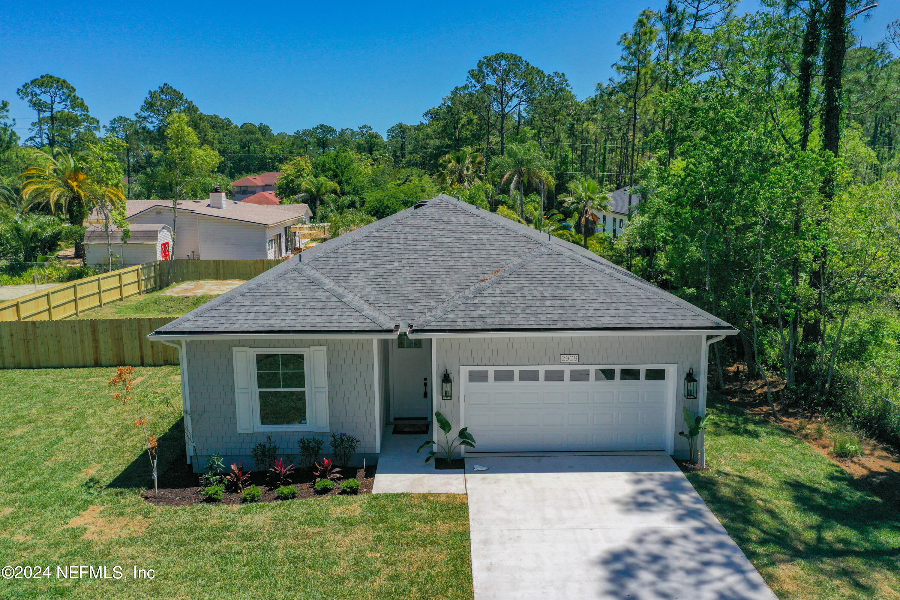 2909 Brougham Jacksonville, FL 32246 - Photo 3 of 46 a view of a house with a yard plants and large tree