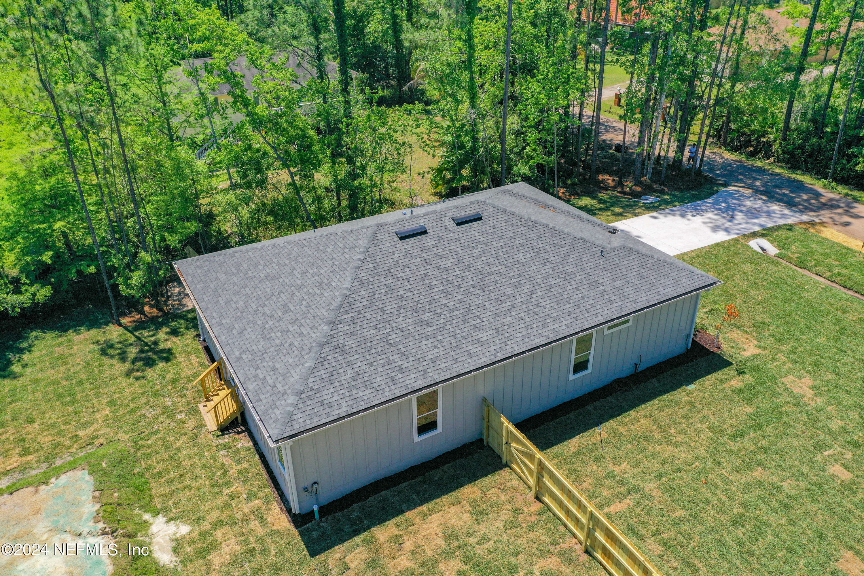 2909 Brougham Jacksonville, FL 32246 - Photo 35 of 46 a wooden bench sitting in the middle of a yard