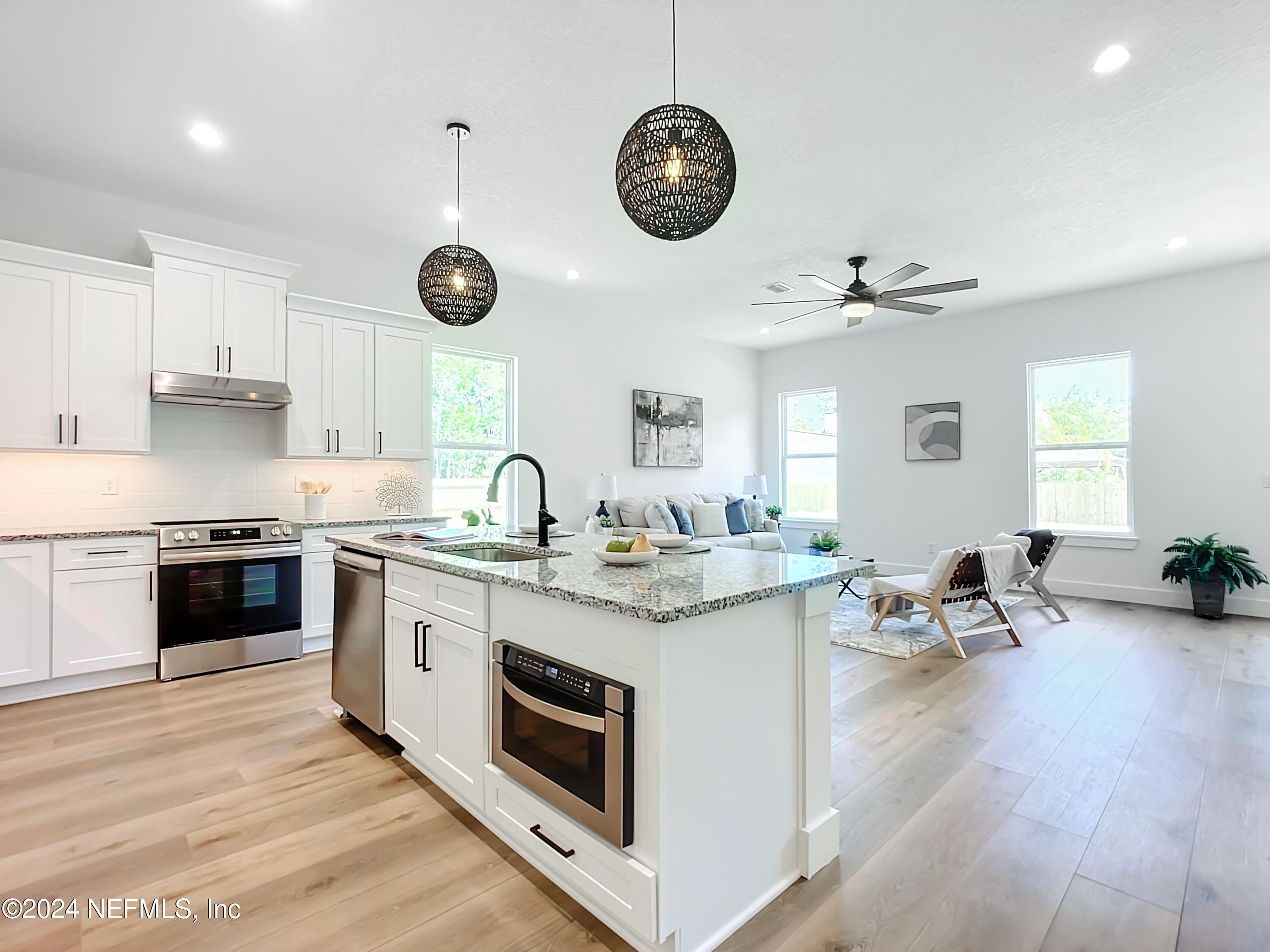 2909 Brougham Jacksonville, FL 32246 - Photo 5 of 46 a kitchen with a stove cabinets a dining table and chairs