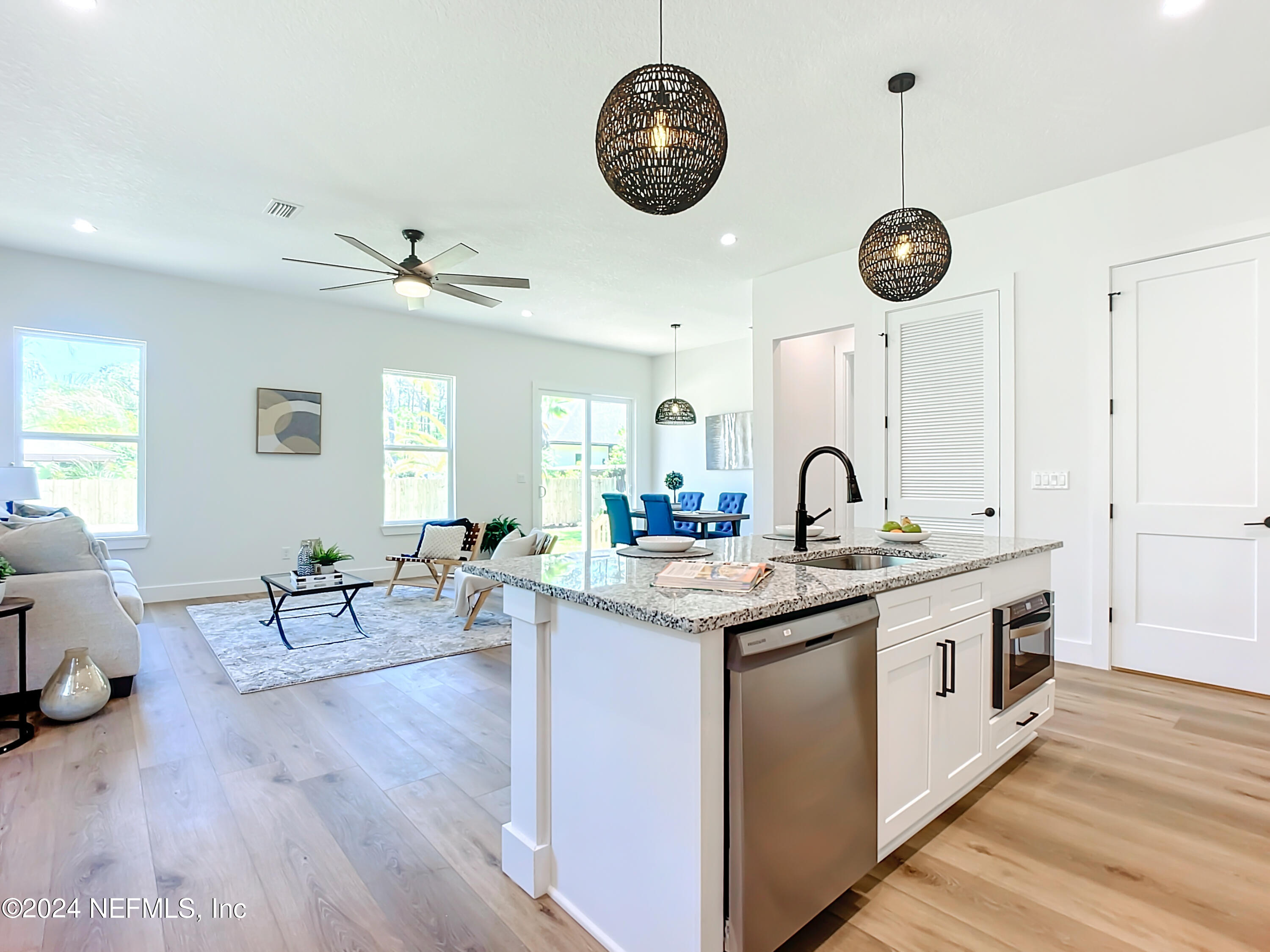 2909 Brougham Jacksonville, FL 32246 - Photo 8 of 46 a kitchen with a stove oven a clock on the wall and a clock on wooden floor