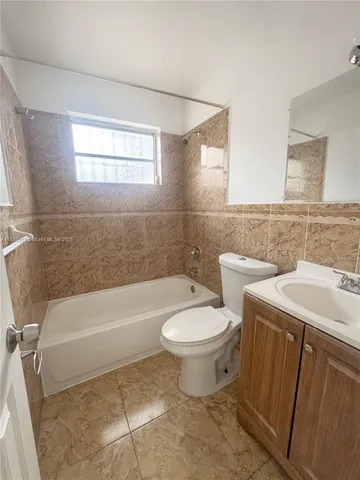 a bathroom with a sink a toilet and bathtub