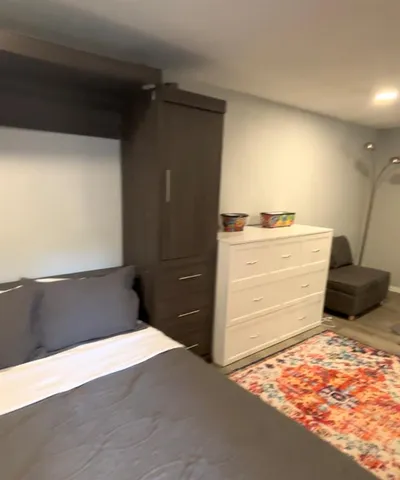 a bedroom with a bed and a mirror