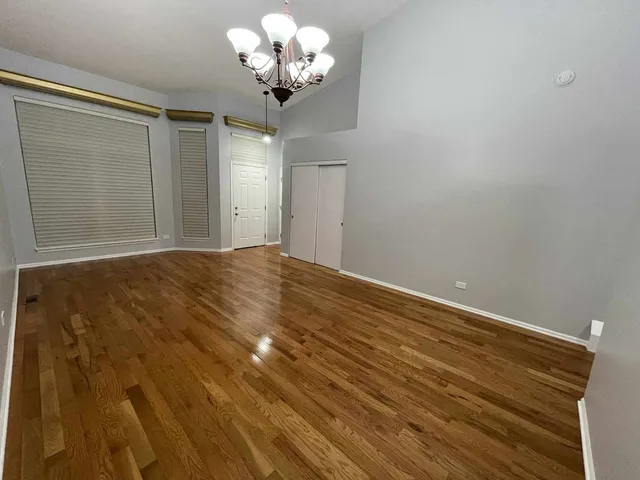 a view of an empty room with a chandelier