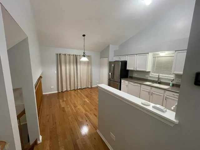 a large kitchen with stainless steel appliances a refrigerator and a sink