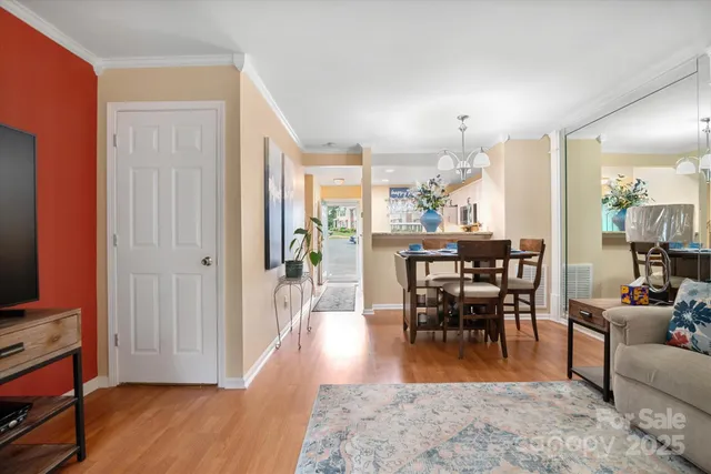 a view of a a dining room with furniture window and wooden floor