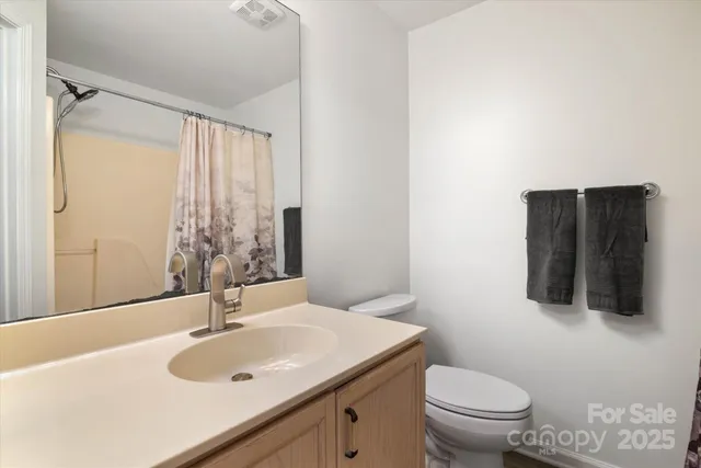 a bathroom with a sink toilet and mirror