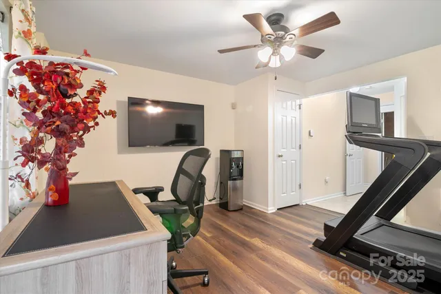a view of a workspace with furniture and a flat screen tv