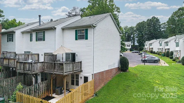 a view of a house with wooden deck and furniture