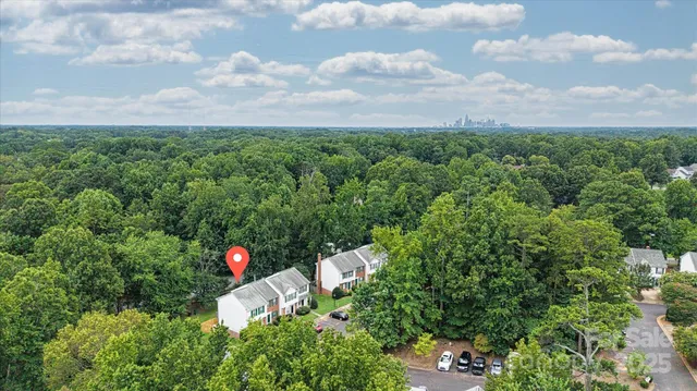 a aerial view of a house with a yard and lake view