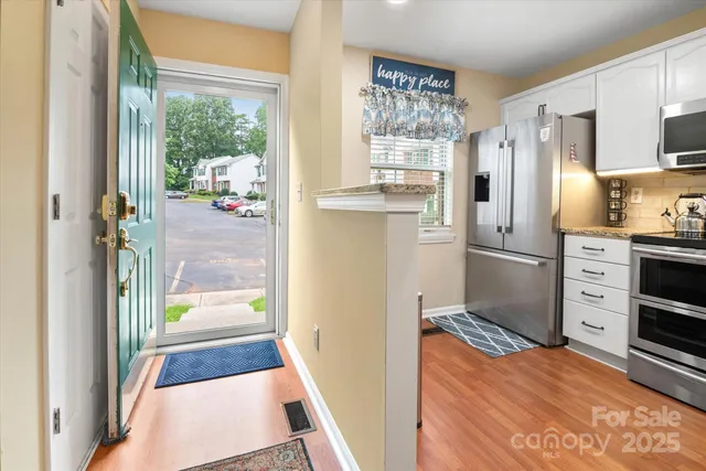 a kitchen with stainless steel appliances a refrigerator and a stove
