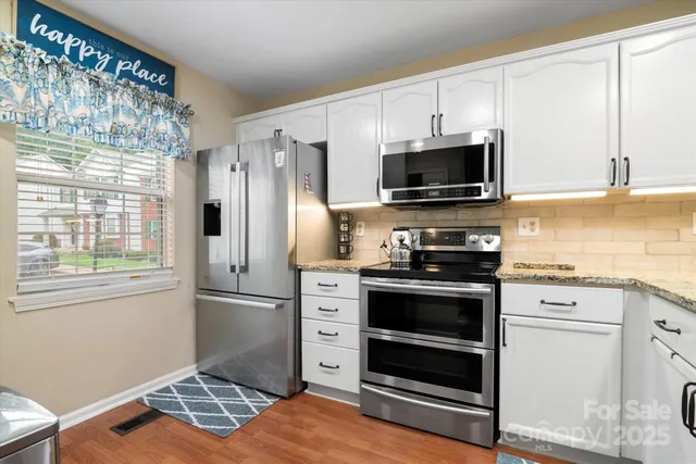 a kitchen with stainless steel appliances a stove microwave and refrigerator