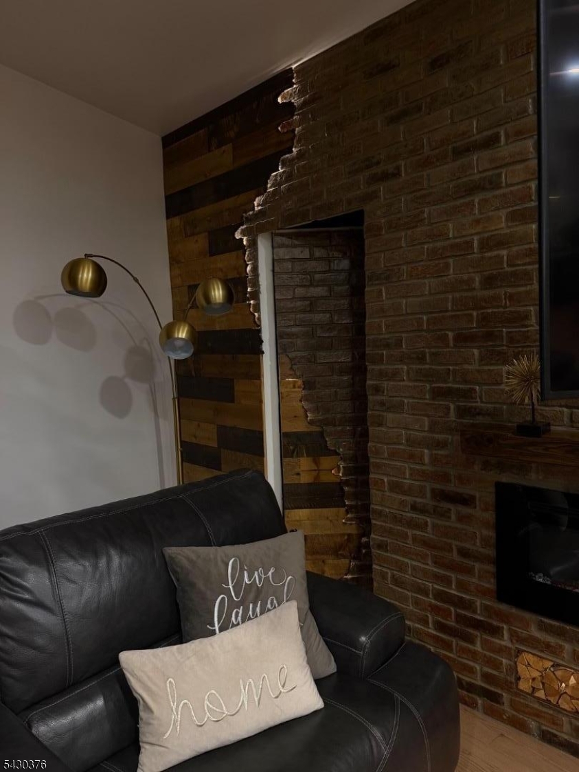 15 Tichenor Street, Unit 405 Newark, NJ 07114 - Photo 12 of 20 a living room with furniture and a fireplace