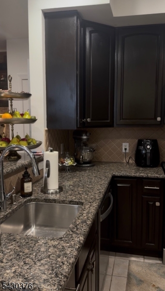 15 Tichenor Street, Unit 405 Newark, NJ 07114 - Photo 15 of 20 a kitchen with granite countertop a sink a stove and cabinets