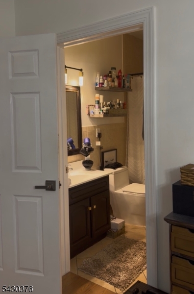 15 Tichenor Street, Unit 405 Newark, NJ 07114 - Photo 3 of 20 a bathroom with a tub sink and mirror