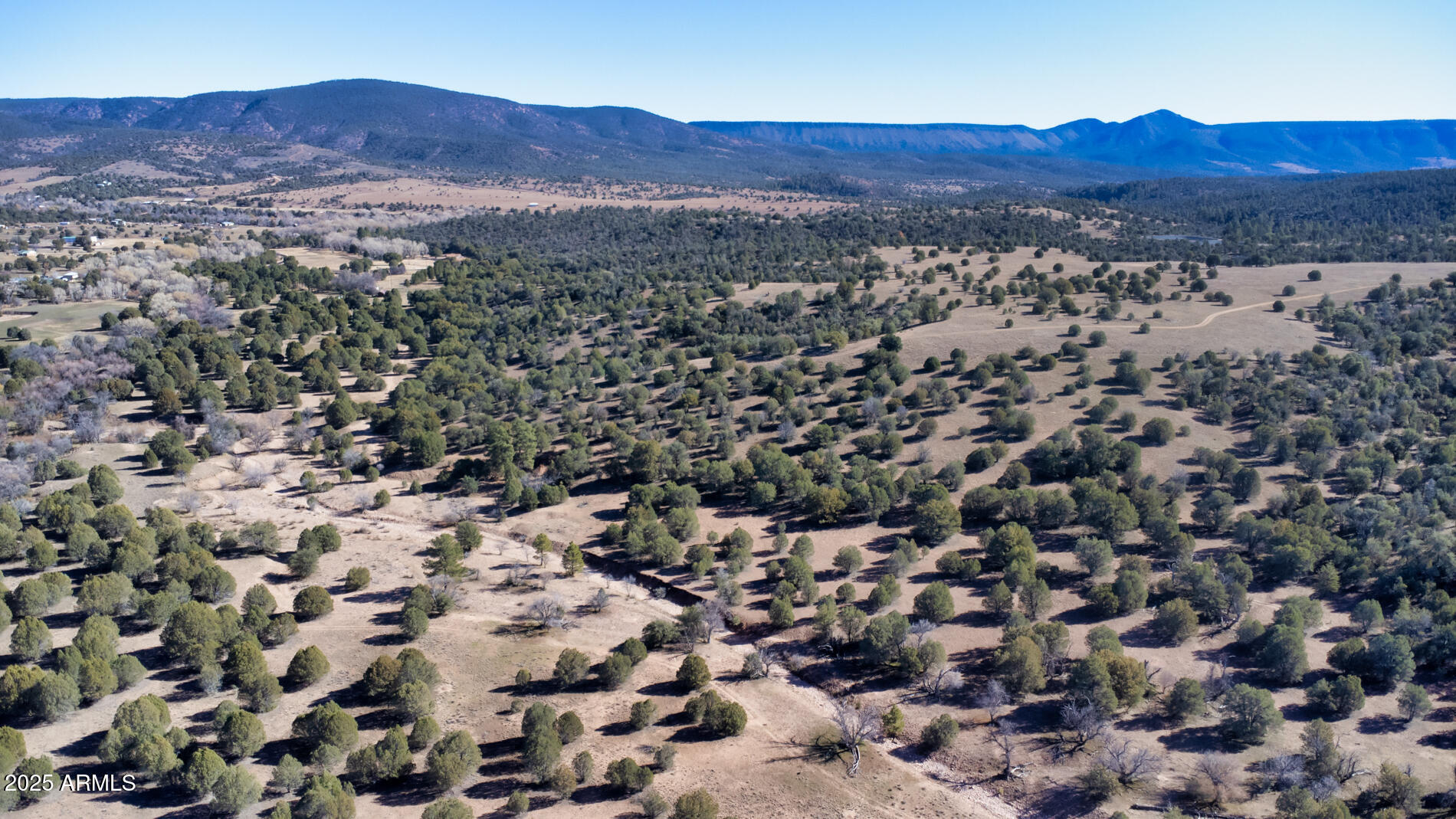 360 Barracks Road, Unit A Young, AZ 85554 - Photo 15 of 17 an aerial view of a red and white house in a field with lots of bushes
