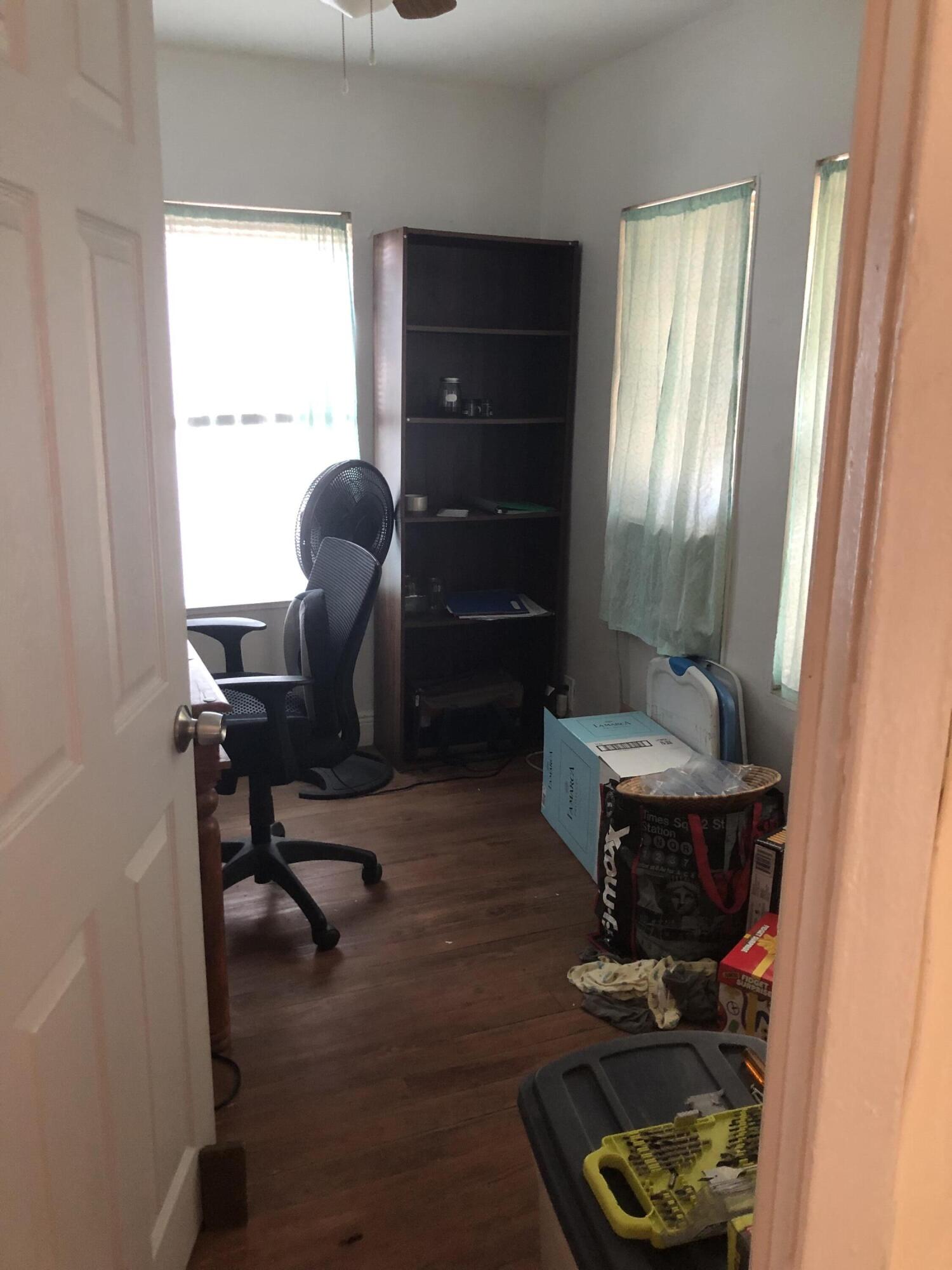 1021 Southwest 5th Street, Unit 2 Miami, FL 33130 - Photo 4 of 7 a workspace with wooden floor and a window