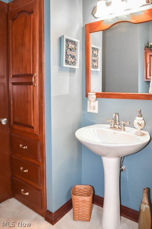 4222 7th Street Northwest Canton, OH 44708 - Photo 13 of 26 Full bath on the main level with a pedestal sink and linen closet.