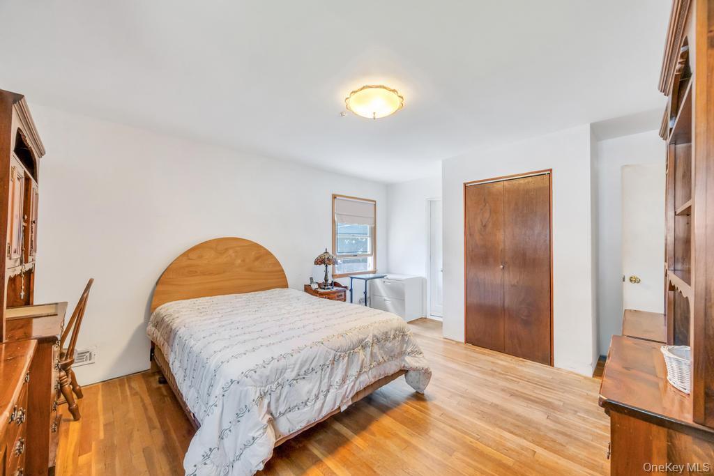 196 Haypath Road Old Bethpage, NY 11804 - Photo 14 of 21 Bedroom featuring a closet and light wood-style floors