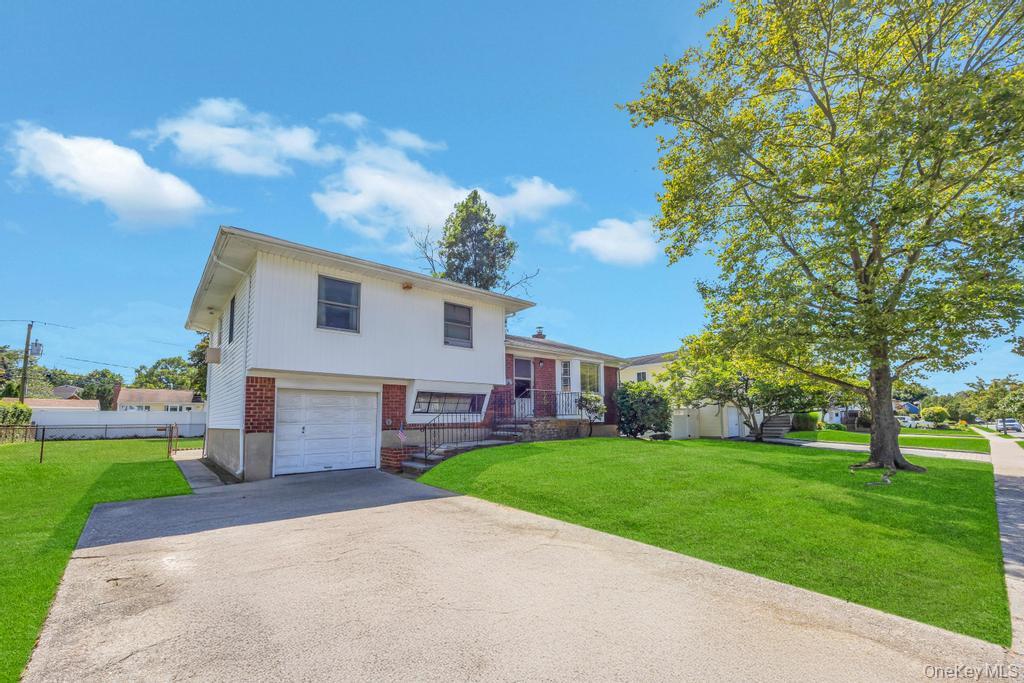 196 Haypath Road Old Bethpage, NY 11804 - Photo 2 of 21 Tri-level home featuring brick siding, asphalt driveway, and an attached garage