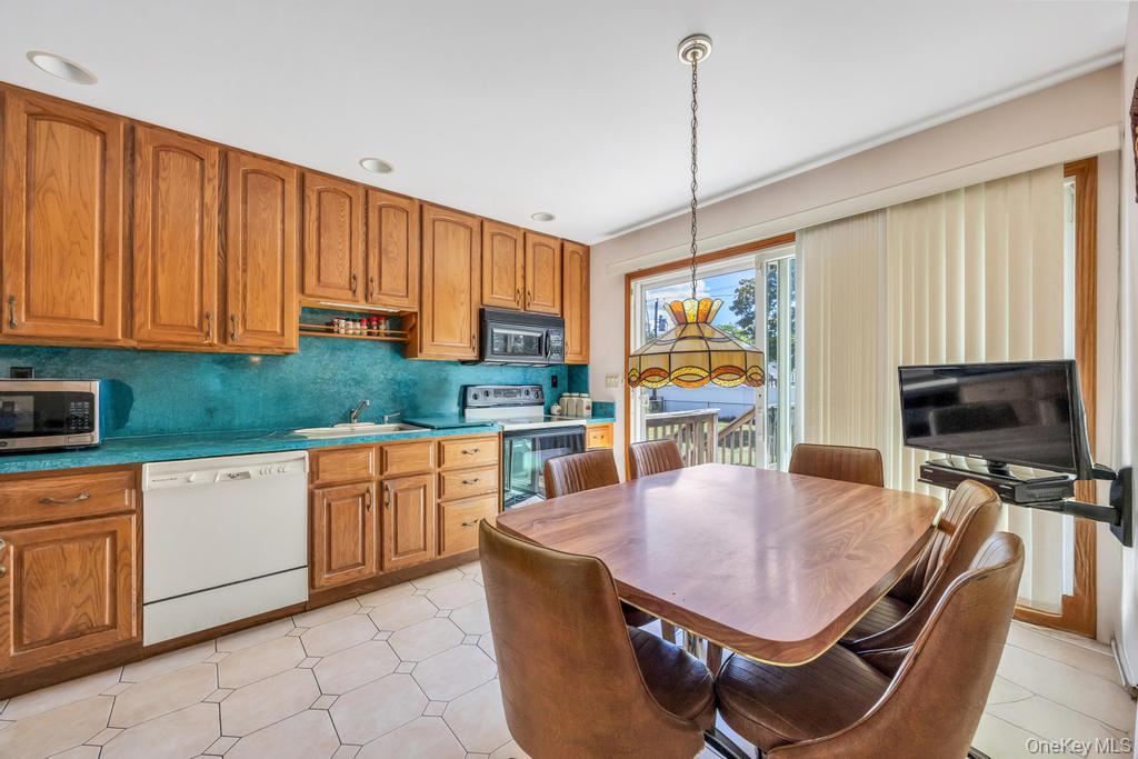 196 Haypath Road Old Bethpage, NY 11804 - Photo 3 of 21 Kitchen featuring brown cabinetry, dishwasher, hanging light fixtures, and recessed lighting