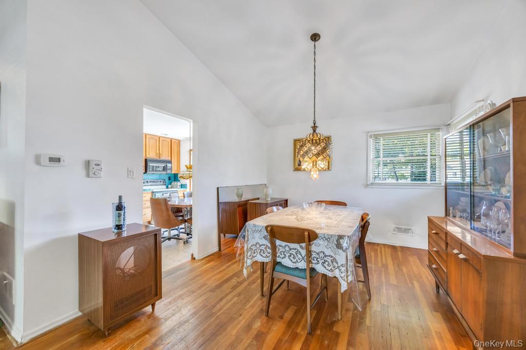 196 Haypath Road Old Bethpage, NY 11804 - Photo 5 of 21 Dining space featuring vaulted ceiling and light wood-style floors